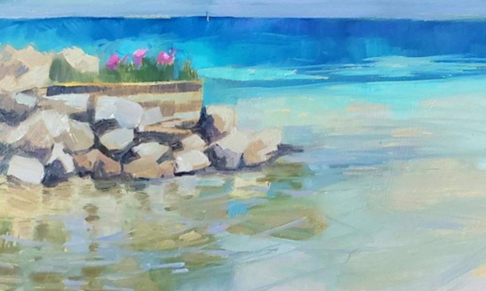 beach scene of water with rocks along the shore